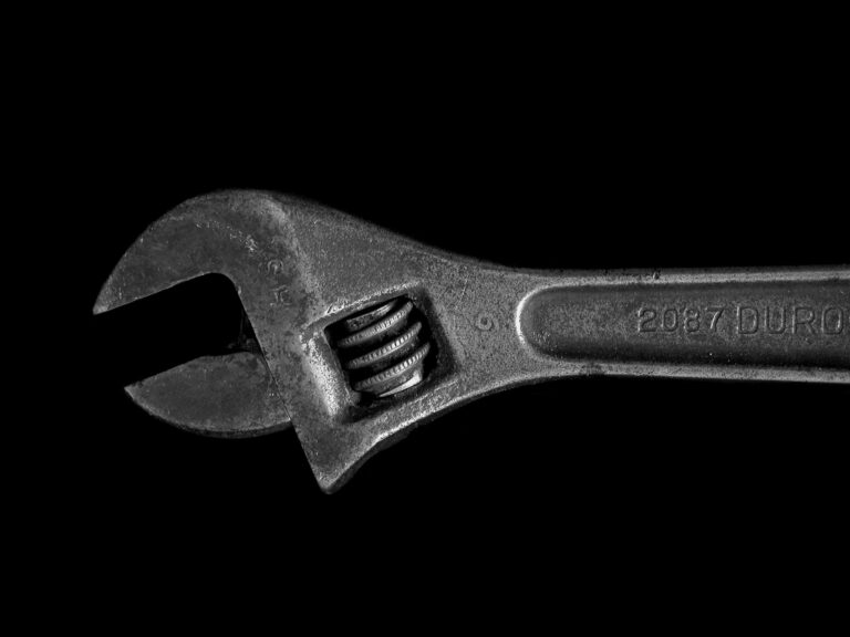 Close-up of an adjustable wrench on black background representing hidden SEO fixes