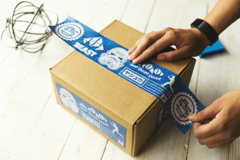 Hands opening a branded ecommerce package representing new arrivals and trending products