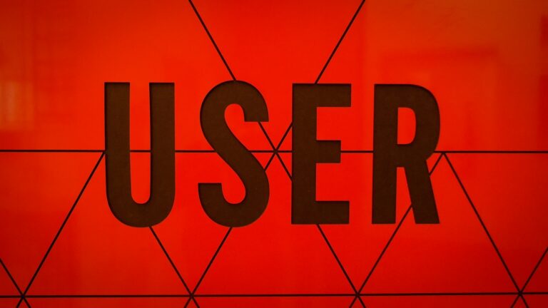 The word USER displayed on a red geometric background representing user-centric personalization